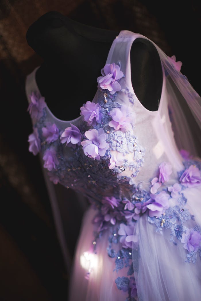 Close-up of a floral violet wedding dress on a mannequin highlighting elegance and fashion.